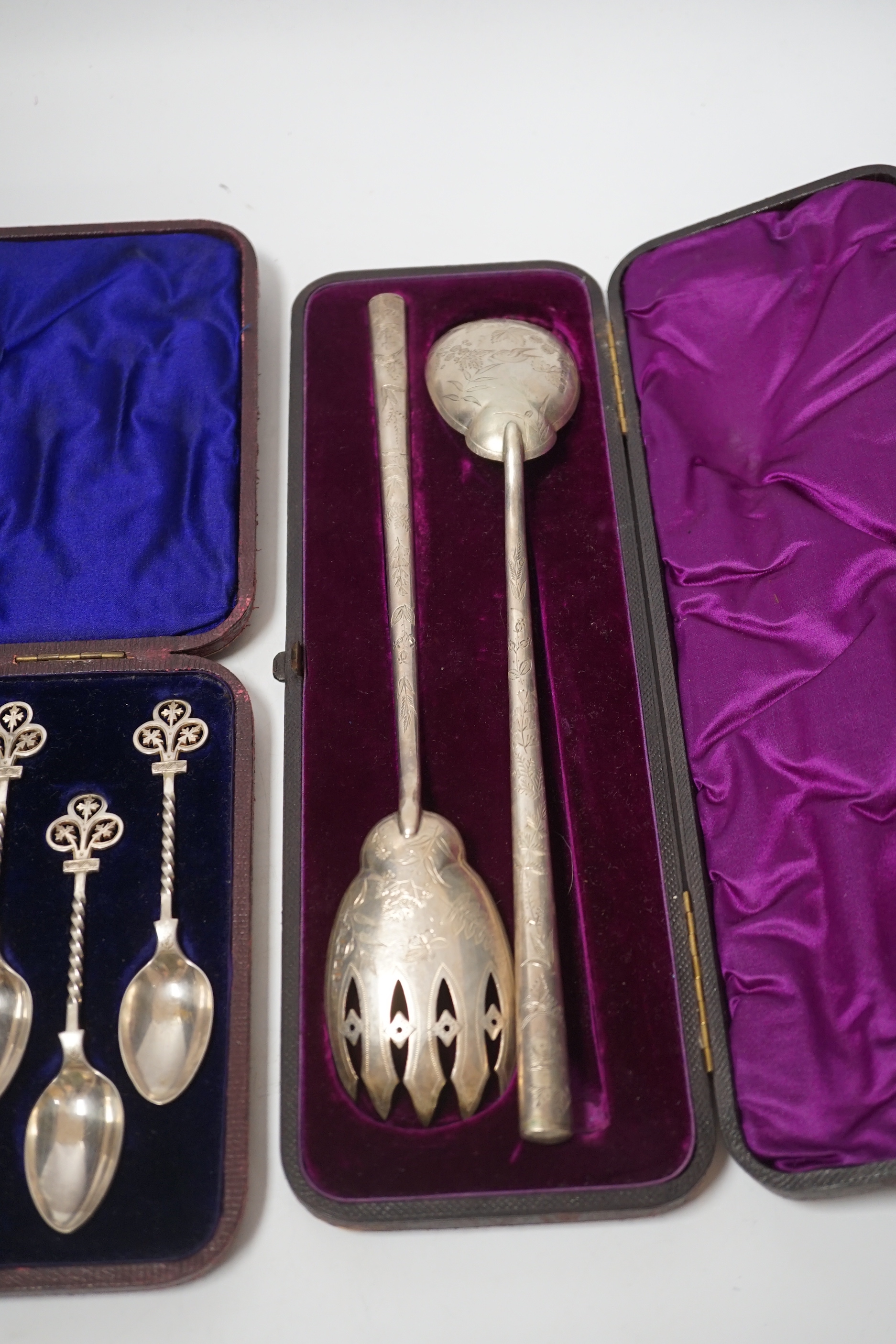 A cased pair of Victorian aesthetic period silver salad servers, Atkin Brothers, Sheffield, 1881 and a cased set of silver teaspoons, sugar spoon and tongs.